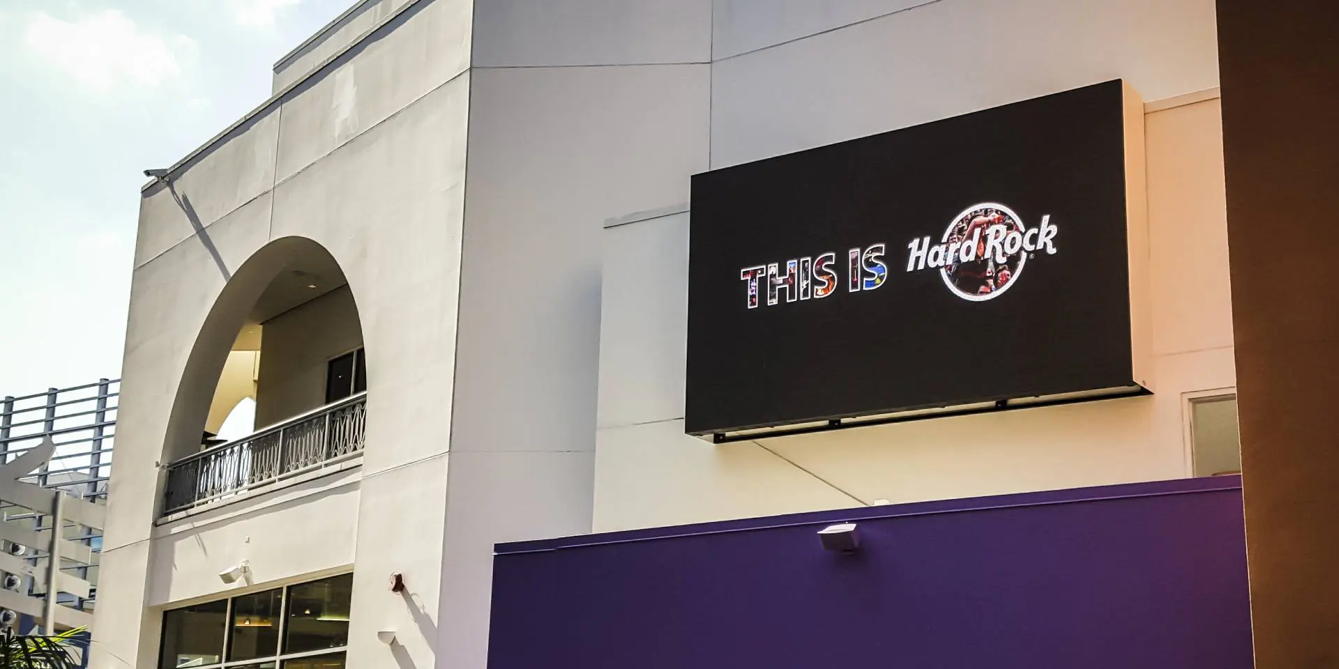 A large screen television mounted on the side of a building.