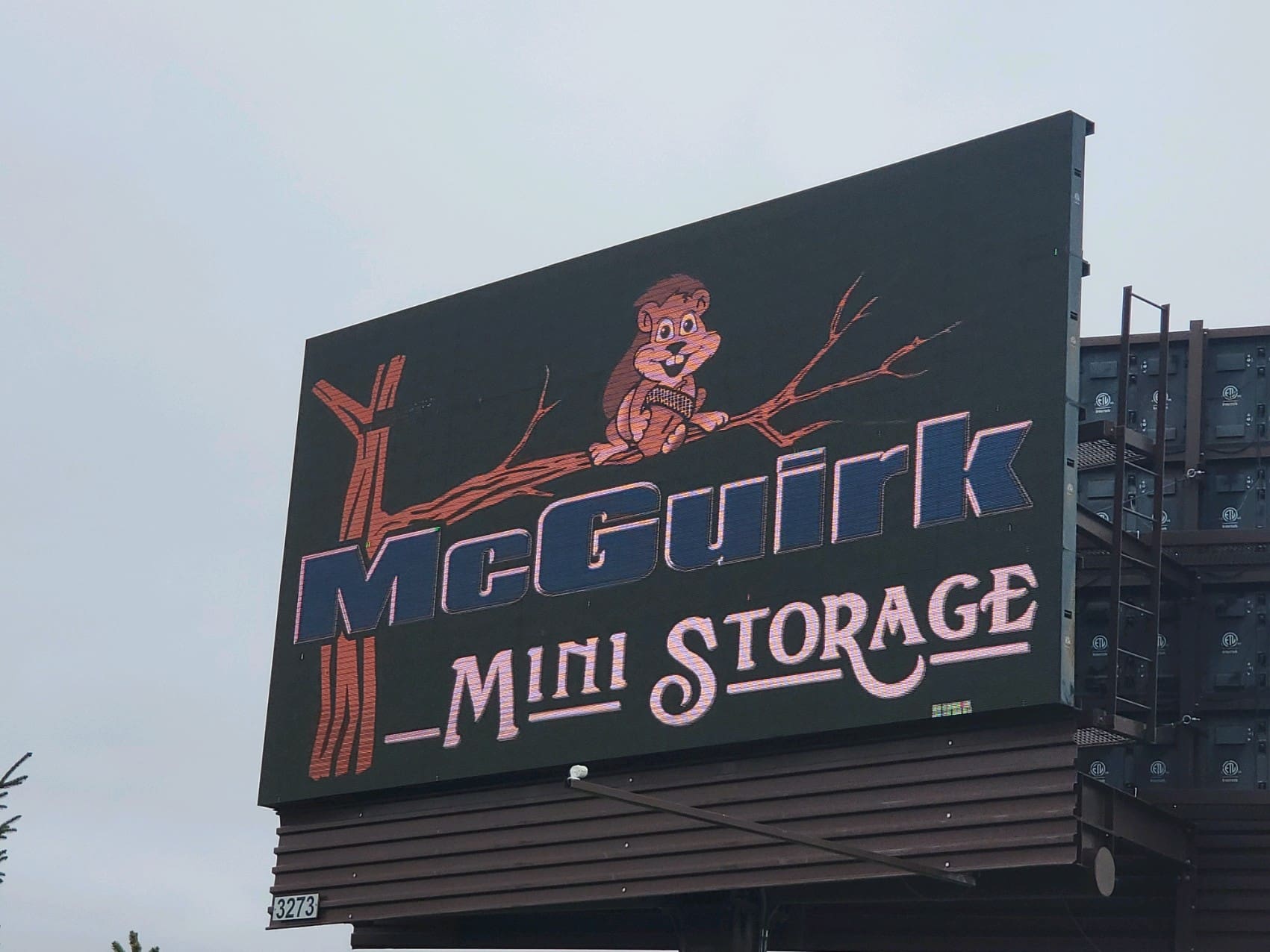 A sign for the mcquirk mini storage facility.